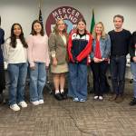 Islander Middle School eighth-grader Abigail Nissim (middle) is flanked by her language arts teacher Whitney Swope and school co-principal MaryJo Budzius as they join the school board directors at their March 14 meeting. Photo courtesy of the Mercer Island School District