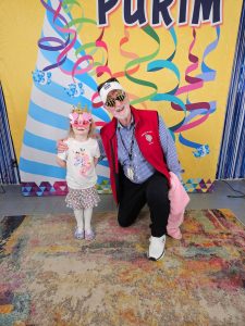 Esme Parks, 5, and John Hamer, 77, at the Purim Festival on March 24. Courtesy photo