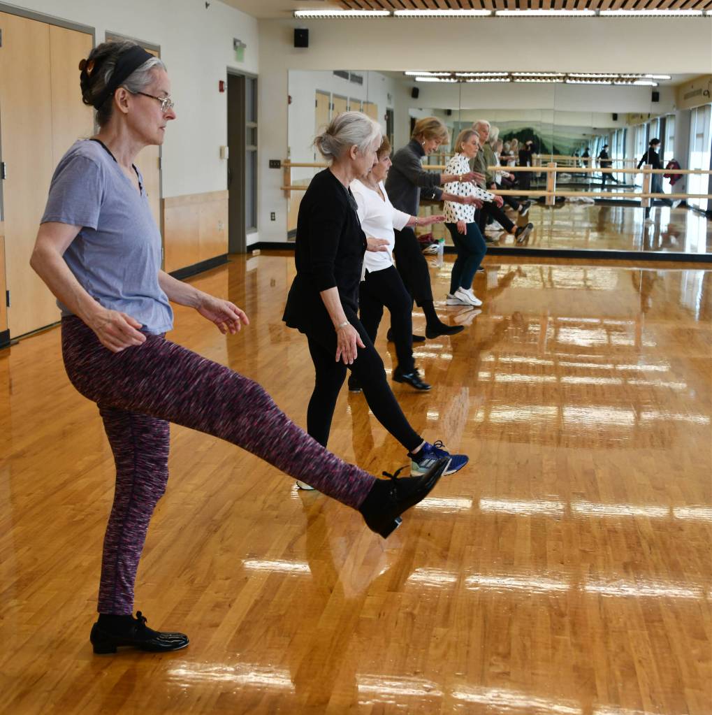 Seniors get in some leg lifting while dancing to a Frank Sinatra tune. Andy Nystrom/ staff photo