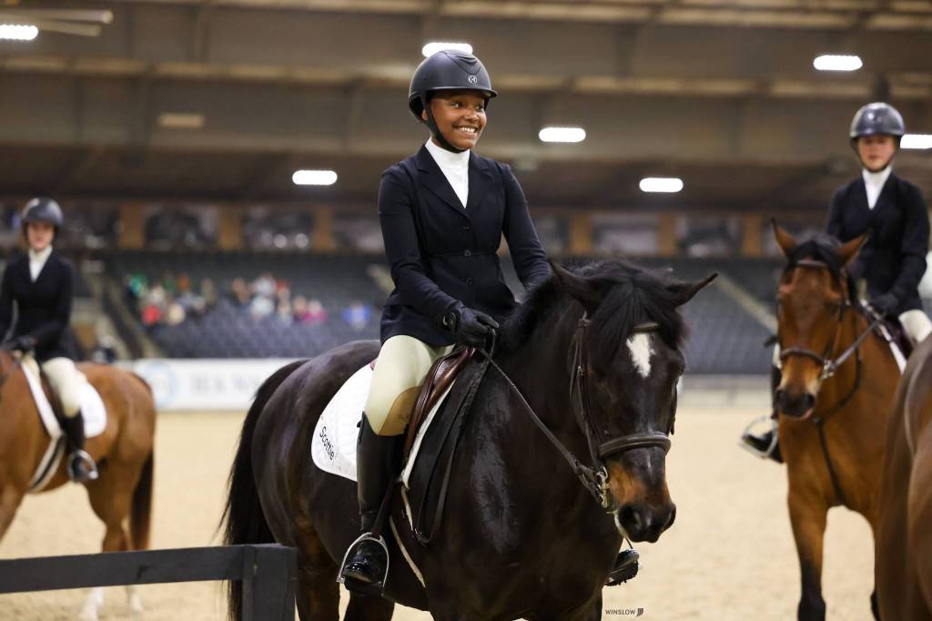 Mercer Island High School sophomore Gabby Frederick, 15, (pictured in the center) won the varsity equitation on the flat competition in her age group  which included high school seniors  at the Interscholastic Equestrian Association (IEA) National Finals from April 25-28 at the Tryon International Equestrian Center in Mill Spring, North Carolina. She also won an Intermont Equestrian At Emory & Henry $5,000 equestrian scholarship and her second sportsmanship award, which was voted on by her peers. Courtesy photo