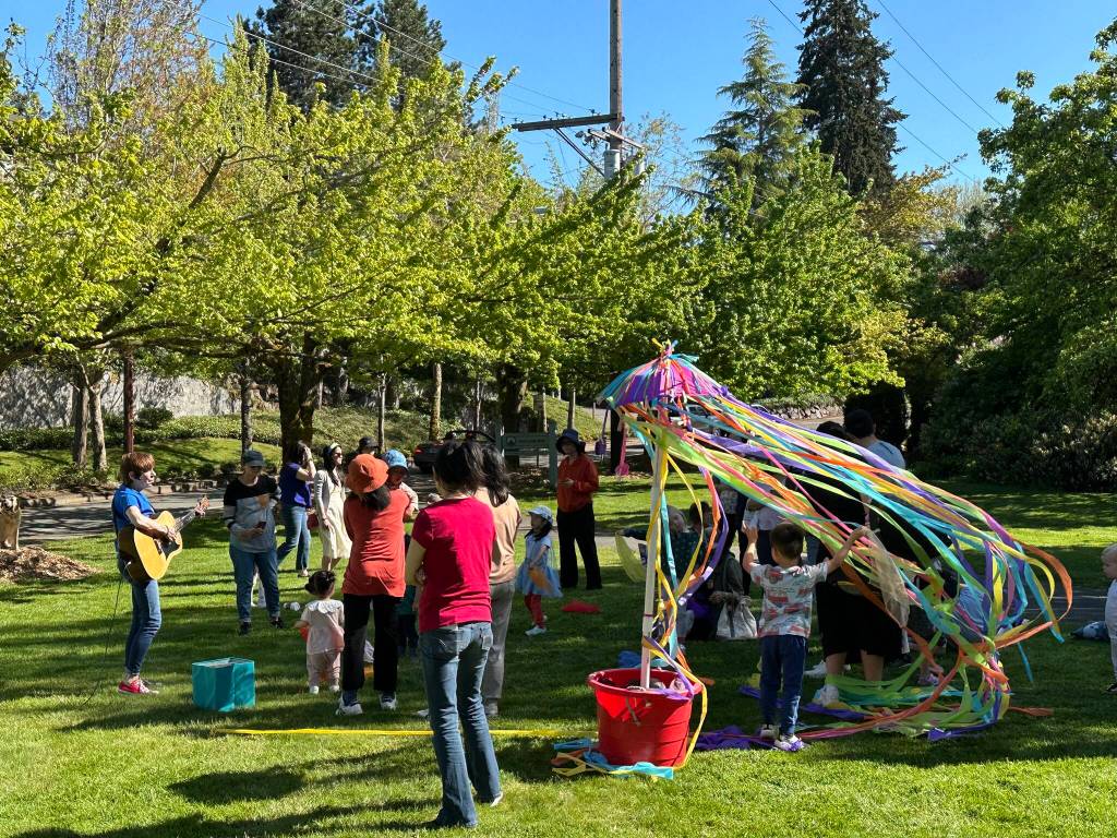 Nancy Stewart, left, performs at the Sing With Our Kids Maypole Dance on May 9 at Mercerdale Park. The event is in partnership with the city of Mercer Island. Photo courtesy of the city of Mercer Island
