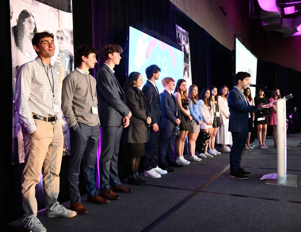 Mercer Islands Tyler Bienstock voices his senior reflection to the crowd as his fellow 2024 Friendship Circle graduates stand behind him. Mia Haslam also gave a senior reflection speech. Andy Nystrom/ staff photo