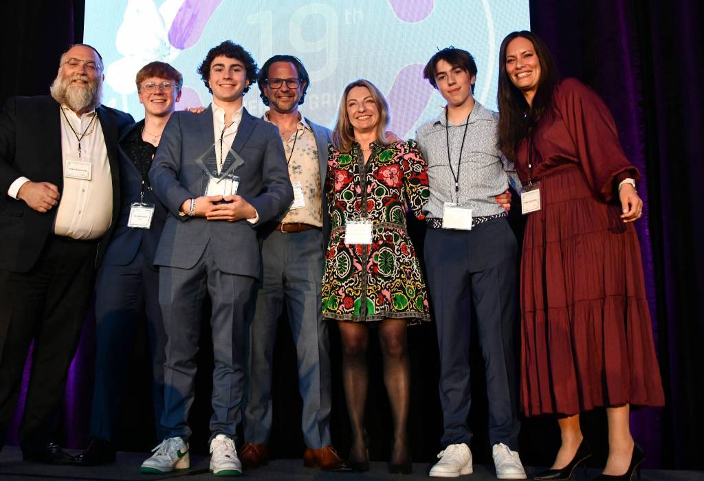 Rabbi Elazar and Esther Bogomilsky flank the Mezistranos, the Friendship Circle honoree family for their robust volunteerism over the years: Dan, Levi, Joel, Hoda and Avi. Andy Nystrom/ staff photo