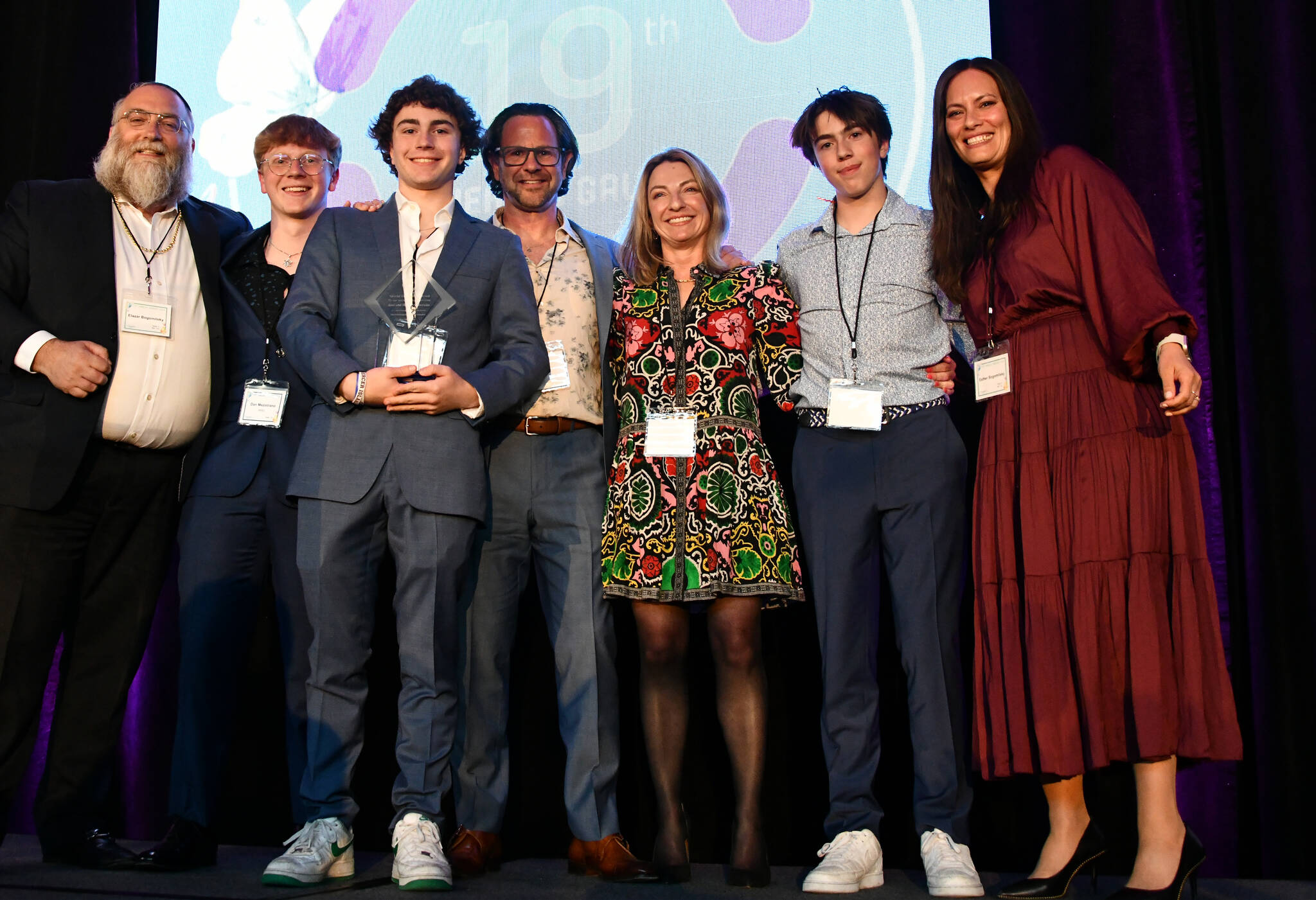 Rabbi Elazar and Esther Bogomilsky flank the Mezistranos, the Friendship Circle honoree family for their robust volunteerism over the years: Dan, Levi, Joel, Hoda and Avi. Andy Nystrom/ staff photo
