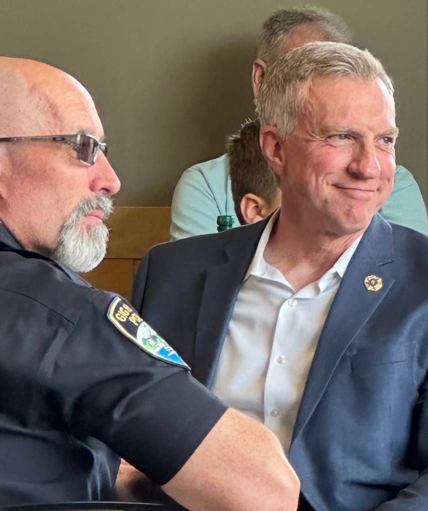 Retired Mercer Island police chief Ed Holmes, right, listening to one of the many tributes. Photo courtesy of Greg Asimakoupoulos