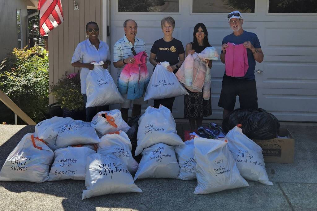 From left to right: Mercer Island Rotarians Novelett Cotter, Benson Wong, Pat Turner, Dana Weiner of Stroum Jewish Community Center, Rotarian John Hamer. The MI Rotary members collected 20-plus bags of childrens lost and found clothing from SJCC and Mercer Island School District. They washed, sorted and folded all the clothes, which will now be donated to local nonprofit organizations that help low-income families. Courtesy photo by Mariana Parks