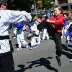 A Mercer Island Martial Arts student kicks up a storm during the community parade at Summer Celebration on July 13 along 78th Avenue Southeast. Andy Nystrom/ staff photo