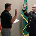Mercer Island Mayor Salim Nice swears in new Mercer Island Police Department Chief Chris Sutter on the afternoon of July 24 in the city council chambers at the Mercer Island Community and Event Center. Andy Nystrom/ staff photo