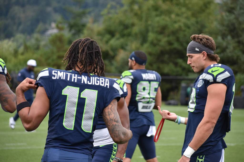 Seahawks wide receivers Jaxon Smith-Njigba and Jake Bobo chatting during the warm-up section of practice. Photos by Ben Ray / Sound Publishing