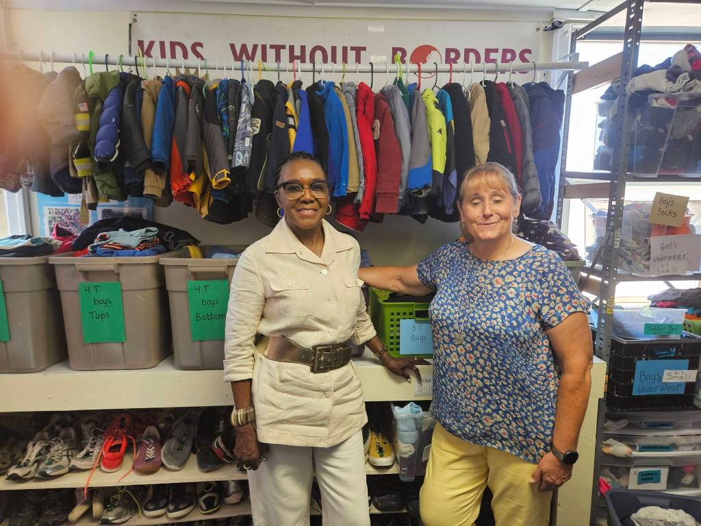 Novelett Cotter of Mercer Island and Katrina Dohn of Tukwila Rotary Clubs, at Kids Without Borders Childrens Clothing Bank, started by Dohn. (Photo by John Hamer)