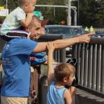 Andy Nystrom/ staff photo
Marcin Lobrow of Mill Creek points toward the Blue Angels while his sons, Oliver, 3 (top), and Tomek, 7, and wife, Michelle, watch the action on Aug. 2 from the Interstate 90 pedestrian/biking walkway near Mercer Island. Also present was their son Franek, 8.