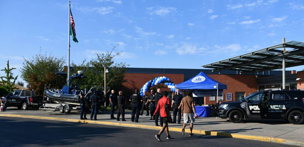 Mercer Island Police Department trucks and a marine patrol vessel, along with officers and Eastside Fire & Rescue workers, are situated at the entrance of the Mercer Island Community and Event Center on Aug. 6 for National Night Out. Andy Nystrom/ staff photo