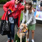 From left, Susan Tiscornia, costumed dog Skylar and Eveline Armitage enjoy the Mercer Island Pride in the Park community celebration on Aug. 24 at Mercerdale Park. Andy Nystrom/ staff photo