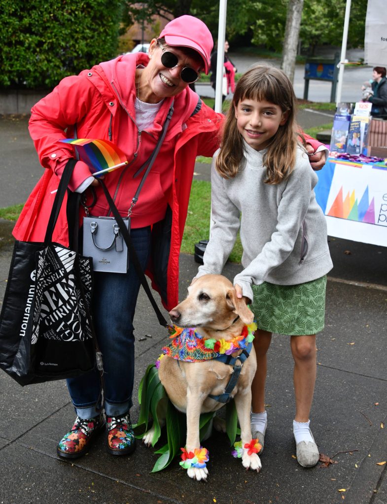 From left, Susan Tiscornia, costumed dog Skylar and Eveline Armitage enjoy the Mercer Island Pride in the Park community celebration on Aug. 24 at Mercerdale Park. Andy Nystrom/ staff photo