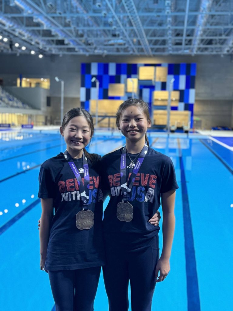 From left, Siran Cao and Isabella Lin pose on the pool deck at the Pan American Aquatics Championships in Lima, Peru, last month. Photo courtesy of Daniela Garmendia