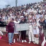 Mercer Island High School Principal Nick Wold and Athletic Director Lindsey Blaine celebrate with students during the Oct. 5 Homecoming football game at Islander Stadium on being named a T-Mobile Friday Night 5G Lights program $5K winner. The Islanders beat Newport, 31-10. Islander fans lent overwhelming support and school spirit to get the T-Mobile win. Local T-Mobile representative Jay Lee and staff members presented a $5,000 check to Blaine at halftime. The schools next goal is to be named a top 16 finalist. Island resident Rob Wolf apprised the school about the promotion. Photo courtesy of the Mercer Island School District