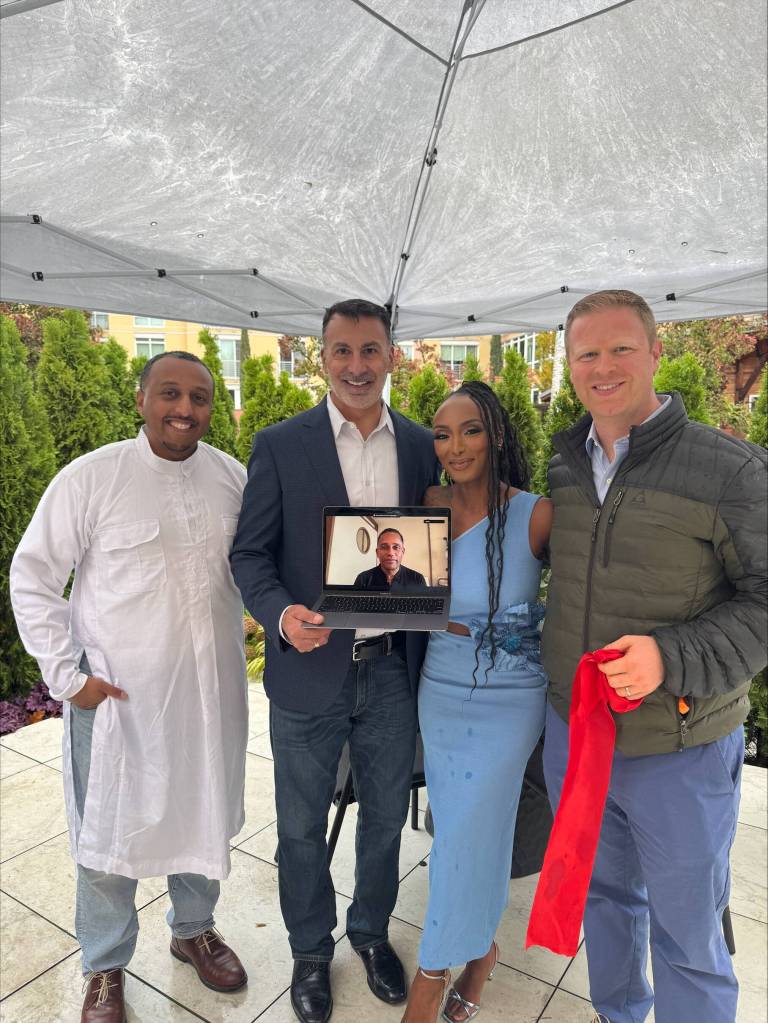 Pictured at the ASA grand opening on Oct. 26 are: from left, Boon Boona Coffee owner Efrem Fesaha, Mayor Salim Nice, ASA owner and general manager Mizan Howard, Deputy Mayor David Rosenbaum, and on the computer screen, ASA owner Hill Harper. Photo courtesy of the Mercer Island Chamber of Commerce