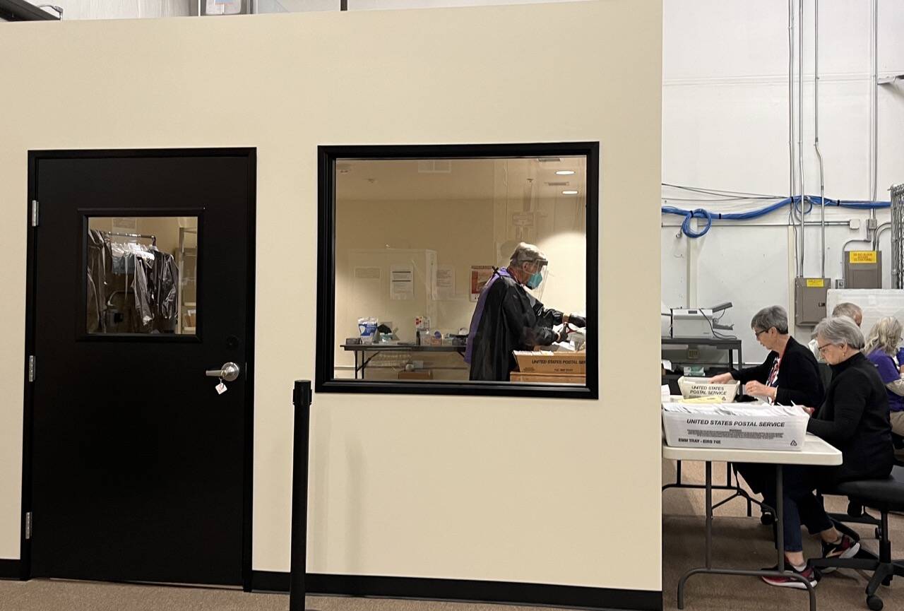 Election workers open mail in a new secure room at Thurston Countys elections office. The county invested in a separate room to open mail after it was sent an envelope containing fentanyl last year. (Laurel Demkovich/Washington State Standard)