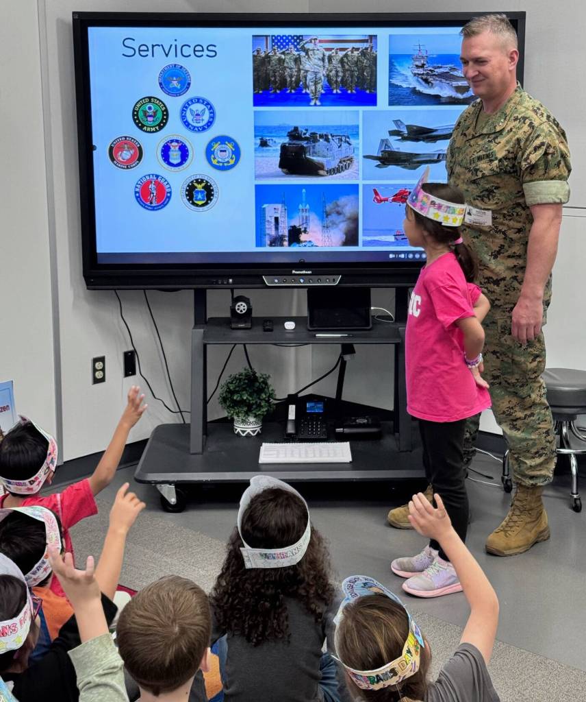 Major General Doug Pierson of the United States Marine Corp visited his daughter Olivias first-grade class and teacher Beth Christofferson at Northwood Elementary School on Nov. 7 to share information about Veterans Day (Nov. 11). Olivias mom, Maggie, was also in attendance and was a huge support in answering the curious questions students had about being in the armed forces. Doug noted about the special visit: It was such an honor for Maggie and me to be able to join you. Thank you for the great opportunity. The questions were so great, all the kids were so engaged, and I was humbled that you offered the chance to come in and talk with the kids about what the military is all about, and the history of Veterans Day. So incredibly awesome of you. Photo courtesy of the Mercer Island School District