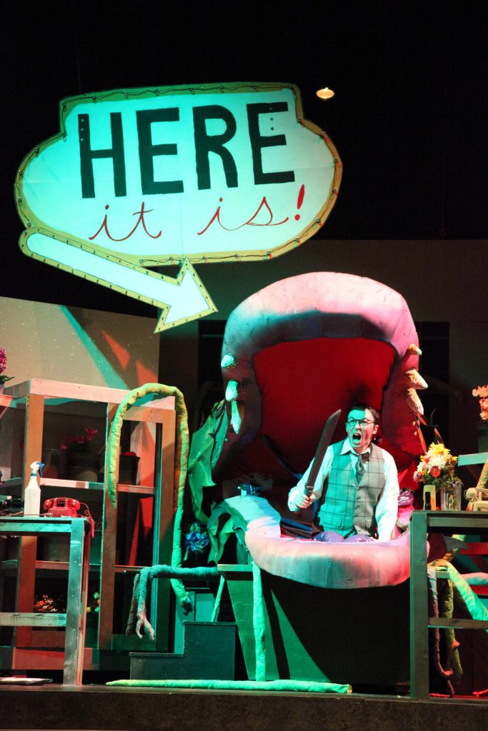 Kyle Gerstel sits inside the carnivorous plant Audrey II during a full dress rehearsal of the Mercer Island High School Drama departments production of Little Shop of Horrors. Photo courtesy of Alec Chvany