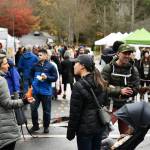 People visit at the market. Some attendees were overheard discussing the storm and power outage. Andy Nystrom/ staff photo