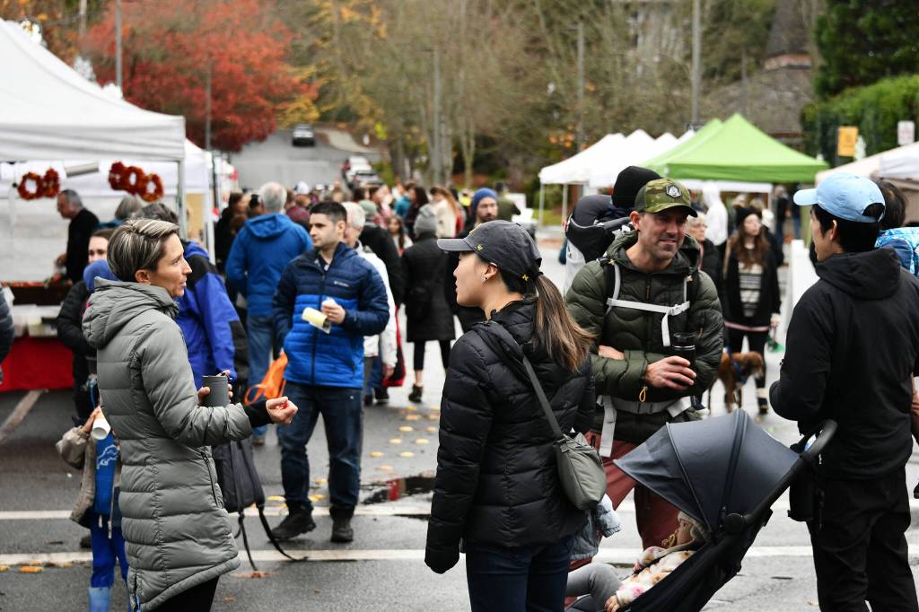 People visit at the market. Some attendees were overheard discussing the storm and power outage. Andy Nystrom/ staff photo