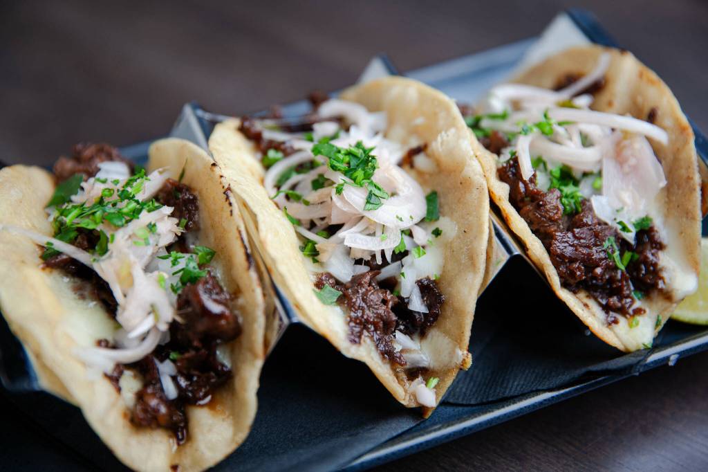 Bulgogi Tacos  thinly sliced ribeye marinated with kalbi sauce, melted cheese, pickled shallots, lime and cilantro. Photo courtesy of Jason Farrish