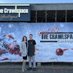 The Crawlspace Gastropub owners Robin and Jason Farrish stand in front of their restaurant, which is currently decorated for the holidays. Photo courtesy of Soyun Chow
