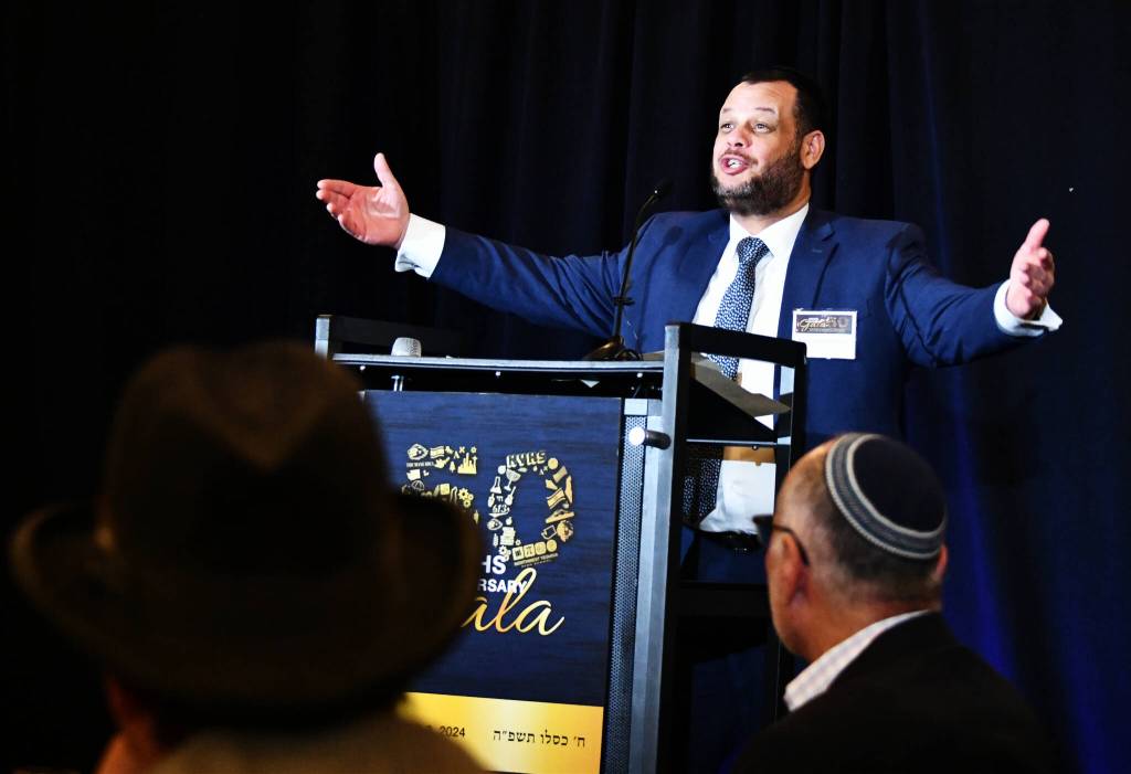 Northwest Yeshiva High School Head of School Rabbi Yehuda Gabay excitedly greets attendees at the schools 50th Anniversary Gala Dinner on Dec. 8 at the Island Synagogue. Andy Nystrom/ staff photo