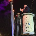 Rabbi Nissan Kornfeld of Chabad Mercer Island used a bucket lift to reach the top of the 12-foot menorah and light first the middle flame, then one on the right, on Dec. 7, 2023, at Mercerdale Park. Reporter file photo