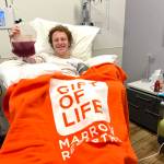 Mercer Islands David Wolf makes a stem cell donation at the NMDP Seattle Collection Center earlier this month. The donation was sent to aid a 24-year-old leukemia patient. Photo courtesy of Lisi Mezistrano Wolf