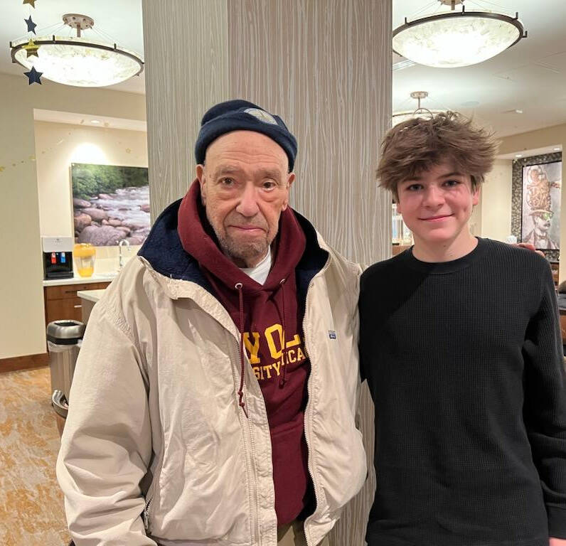 Mercer Island High School sophomore Sean Barneson visits with Howard (Howie) L. Fink, 89, at Aegis Living Mercer Island. Photo courtesy of Colleen Barneson