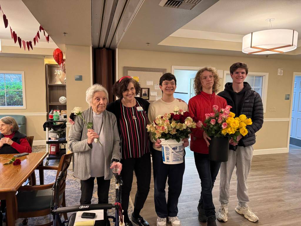 Volunteers Oliver Lee and Leo Saloranta deliver flowers to Island House. Courtesy photo