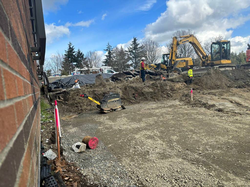 OMA Construction workers make headway on March 18 at the Town Center Parking Area at the former Tullys site. Andy Nystrom/ staff photo