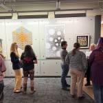 People gather at the Intersections: Math, Art, Truth, Humanity public art exhibition. Photo courtesy of Anne Hritzay