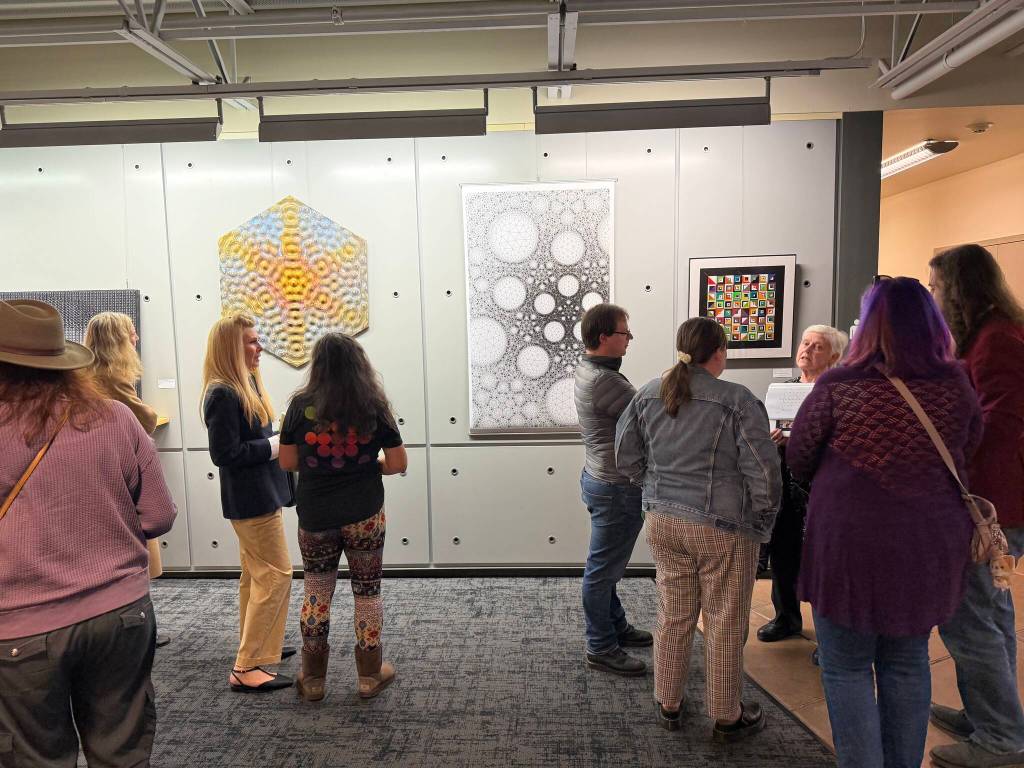 People gather at the Intersections: Math, Art, Truth, Humanity public art exhibition. Photo courtesy of Anne Hritzay