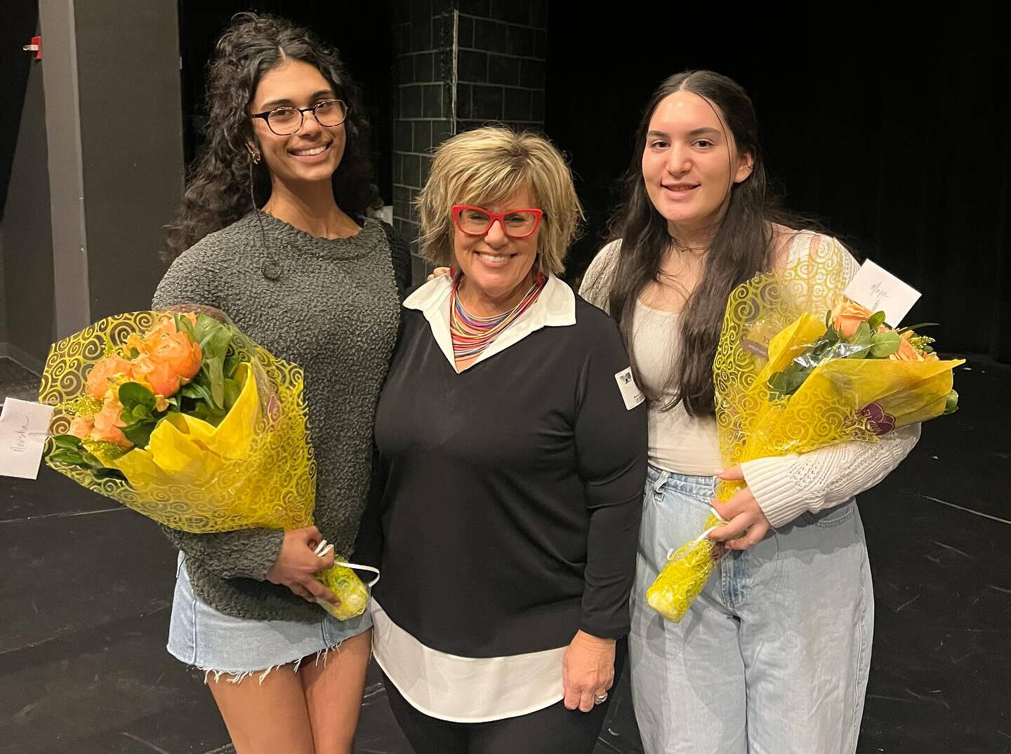 From left to right, Anusha Zaveri, Tami Brooks and Maya Talby gather at the Mercer Island High School sexual assault awareness assembly on March 19. Photo courtesy of the Mercer Island School District
