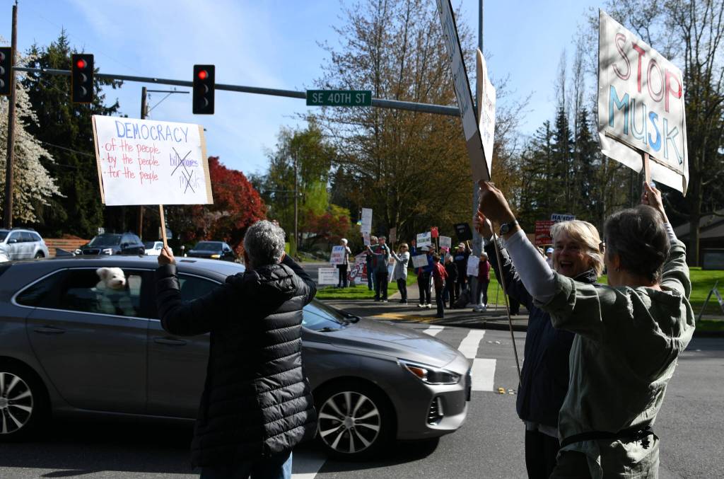 A driver honks in favor of the protesters. Andy Nystrom/ staff photo
