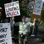 Gene Robertson, center, has spearheaded the Mercer Island peaceful protests against the United States government. Here, she joins protesters on April 13 at the intersection of Island Crest Way and Southeast 40th Street. Protesters stood and waved signs on all four corners. Andy Nystrom/staff photo