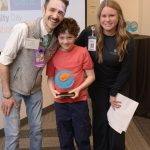 Mercer Islands Emerson Vivion, center, displays his Seattle Childrens Hospital Community Day Hope award alongside Max Williams (Therapeutic Gaming Program specialist with Child Life) and Christina Burmester (Seattle Childrens Foundation development coordinator, community giving). Courtesy photo
