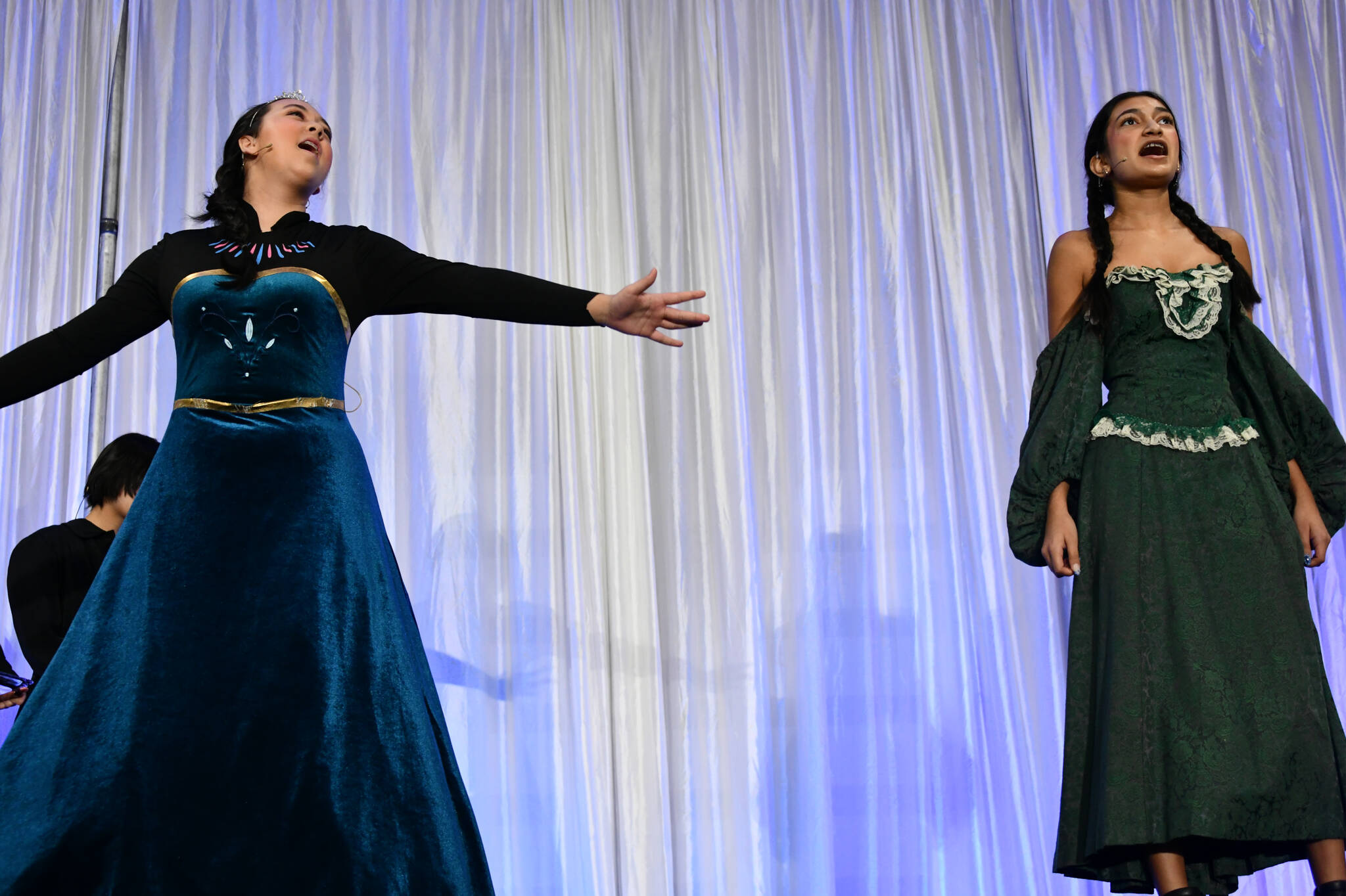 Islander Middle Schools Frozen Jr. cast members, from left to right, Ava Carlson (Elsa) and Shynah Sandhu (Anna) perform at the Mercer Island Schools Foundations Breakfast of Champions fundraiser on April 29 at Mercer Island High School. Also performing were Edi Wang (Butler) and Cordelia Reese (Housekeeper). Andy Nystrom/ staff photo
