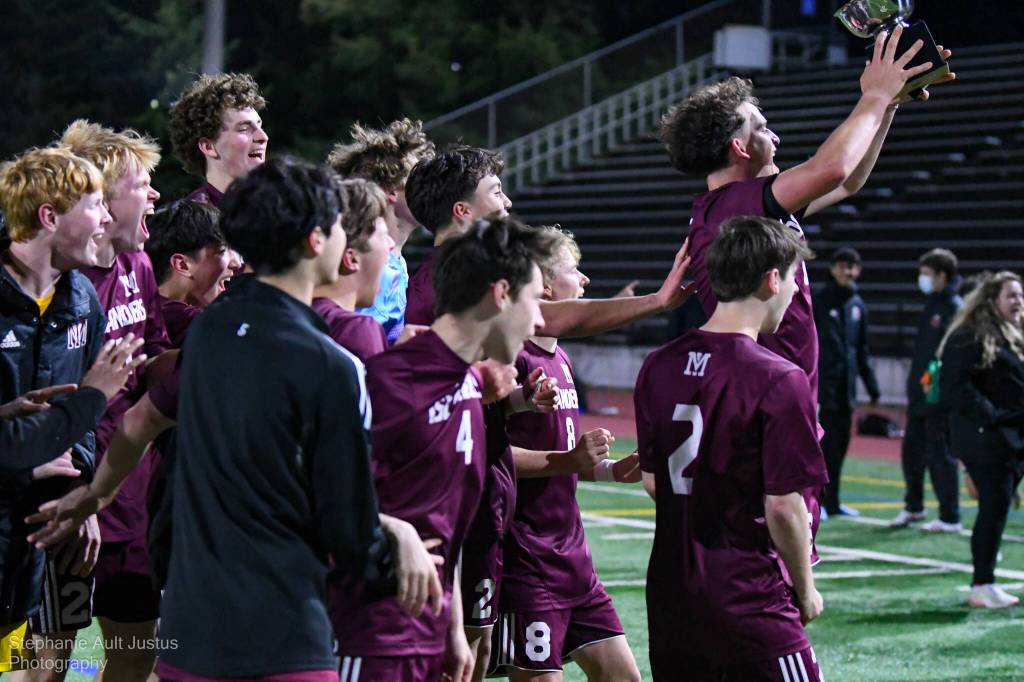 Mercer Island High School players celebrate their title as senior Charlie Frink lifts the championship trophy. Photo courtesy of Stephanie Ault Justus