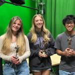 Left to right: Hannah Moeller, Hadley Holtzclaw and Minh Luu hold their Telly Awards in the MIHS.tv studio. Photo courtesy of the Mercer Island School District