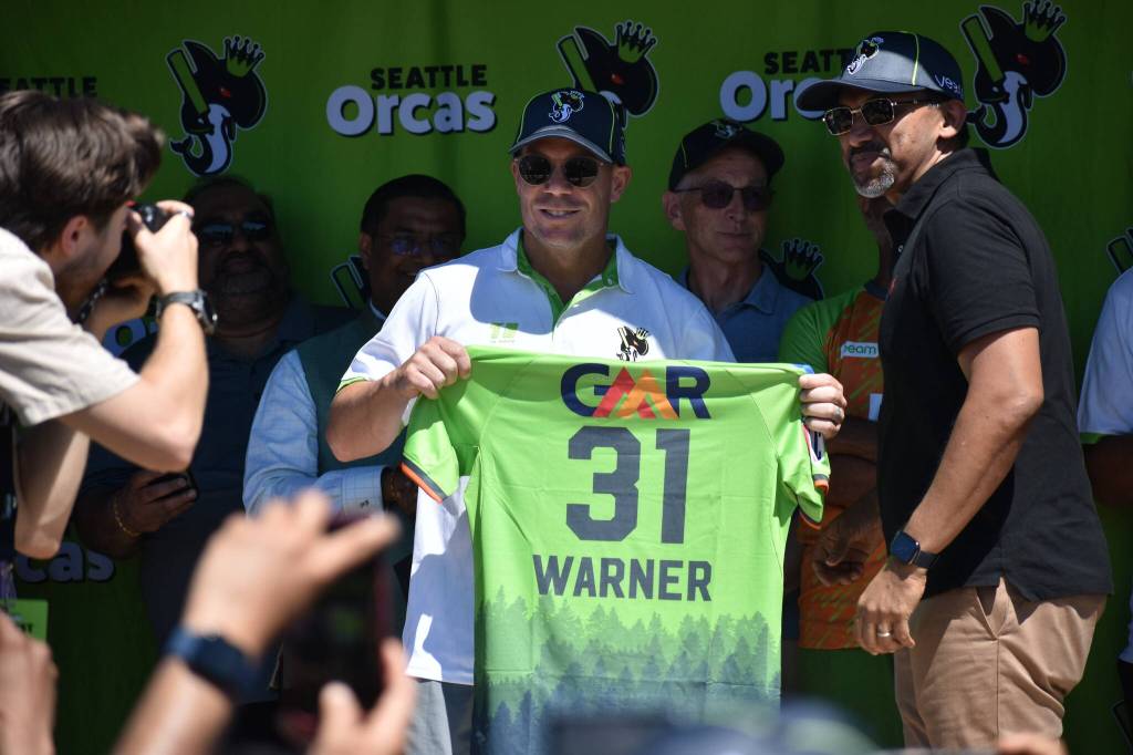 David Warner holds up his jersey for the Seattle Orcas. Ben Ray / The Reporter