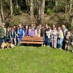 Members of Mercer Islands Clarke family gather at Clarke Beach Park on April 5 to honor Nile Kinnick Clarke with a bench and plaque. Nile was a Mercer Island teacher and coach for more than 50 years who passed away in 2021 at the age of 74. Courtesy photo