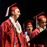 Kyle Gerstel, left, and Ashwin Krishnaswamy, right, with Nikita Kovarskas during the 14-student valedictorian speech. Andy Nystrom/ staff photo