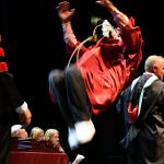 A graduate performs a backflip on stage after receiving his diploma. Andy Nystrom/ staff photos