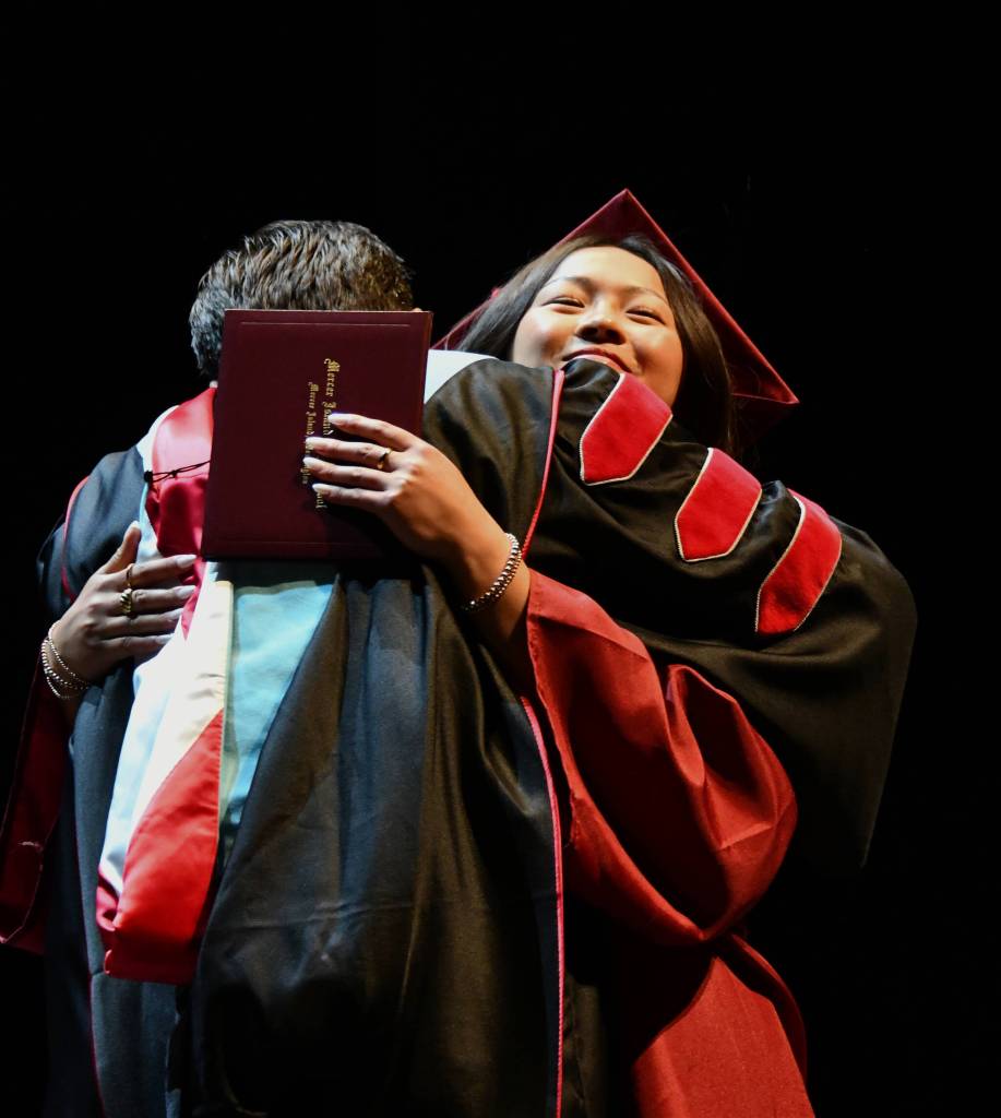 Mercer Island High Schools Ava Zhang hugs Mercer Island School District Superintendent Dr. Fred Rundle after receiving her diploma at the June 16 Class of 2025 graduation ceremony at McCaw Hall in Seattle. Andy Nystrom/ staff photo