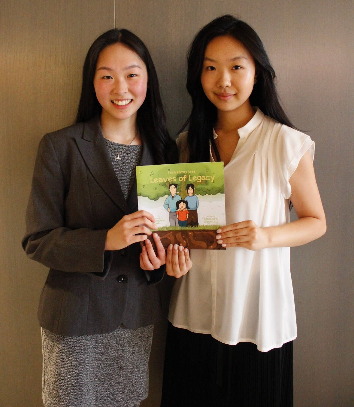 From left, Scarlett Luo and Grace Go with their book, Mias Family tree: Leaves of Legacy. Courtesy photo
