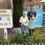 Mercer Island Visual Arts League artist/gardener June Lindsey and muralist Daniel Menezes showing off the flower garden, Free Little Art Gallery and mural in process. Photo courtesy of the Mercer Island Visual Arts League